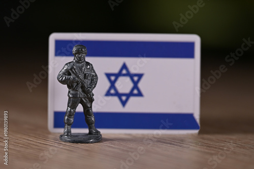 A tin soldier on the background of the Israel flag.