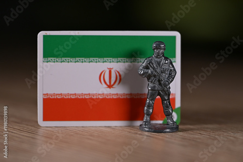 A tin soldier on the background of the Iranian flag.