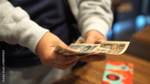 payment debt money banking on JPY Yen banknote in hands finance wealth