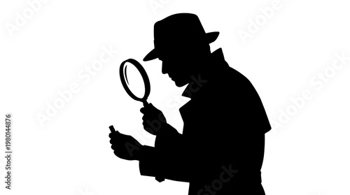 Tableau sur toile Silhouette of detective in hat and trench coat examining small object with magni