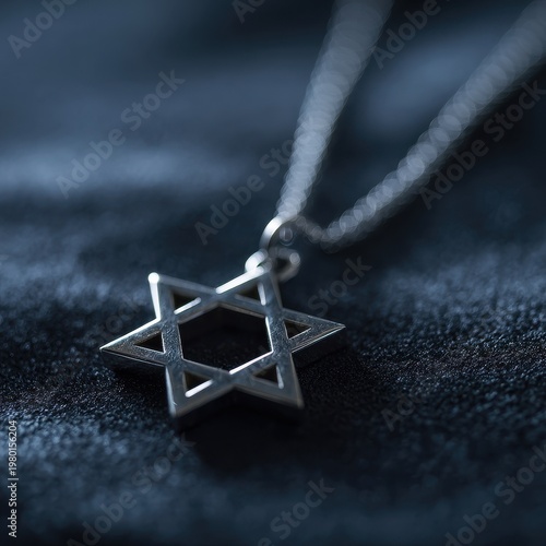 Macro shot of a geometric Star of David charm resting on soft fabric, reflective metal texture