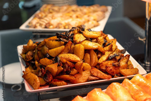 Wallpaper Mural Close-up of golden roasted potato wedges on a white platter Torontodigital.ca