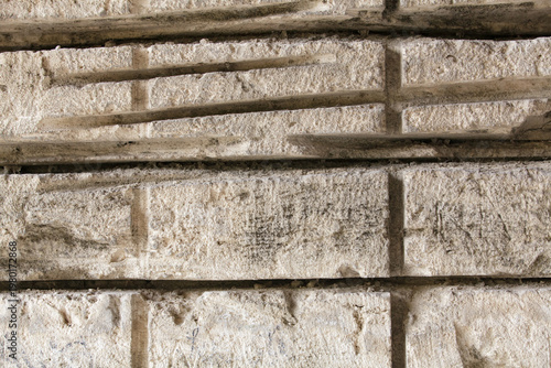 Textured shell rock wall in an old limestone quarry with saw marks
