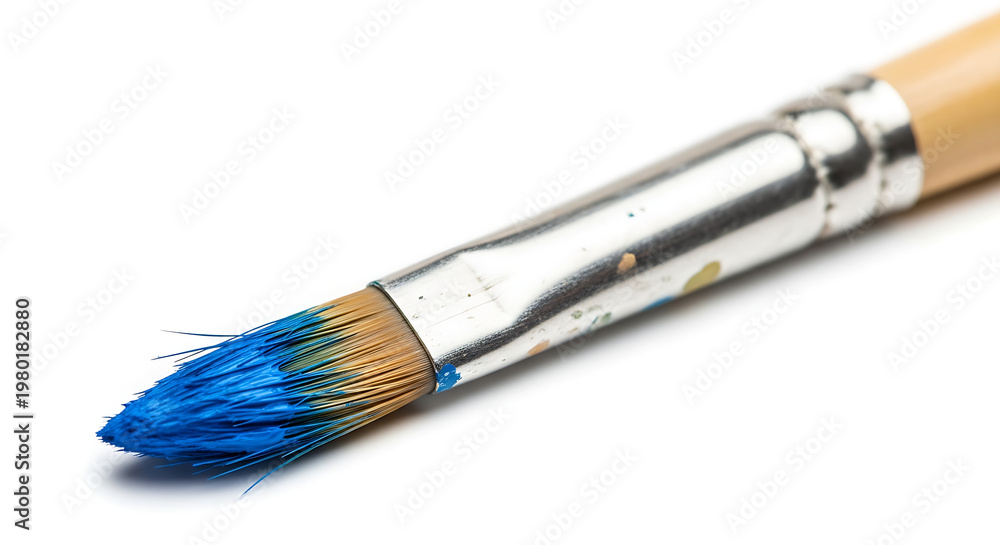 Fototapeta premium Paintbrush with blue paint resting on a clean surface