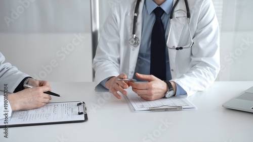 Bilde på lerret Medical professionals consulting, discussing patient health, reviewing test results at a clinic desk, offering healthcare advice