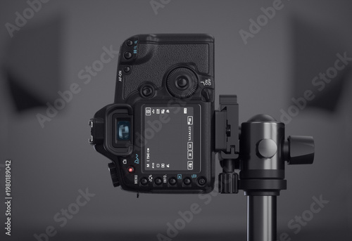 Close-up of a vertical DSLR camera display focusing on a professional photography studio. Black background. Realistic 3D render.