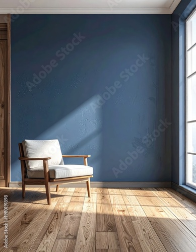 A cozy interior scene features a wooden armchair positioned against a textured blue wall bathed in warm sunlight streaming through a nearby window, creating a serene and inviting atmosphere.