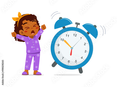 Cute African American child yawning and stretching beside a ringing alarm clock feeling sleepy in morning
