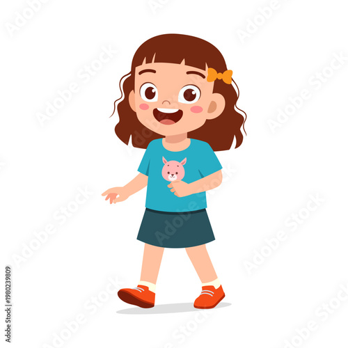 Happy little Asian girl walking with open hands smiling cheerfully wearing a blue pig t shirt and skirt