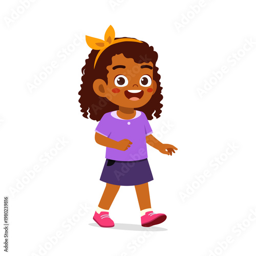 Happy smiling African American little girl walking cheerfully in purple outfit with a yellow bow