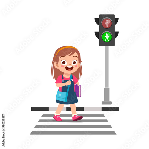 Happy Asian girl cheerfully walking across pedestrian crosswalk with green traffic light holding book