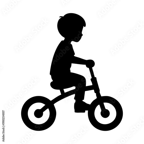 silhouette of a small child riding a balance bike