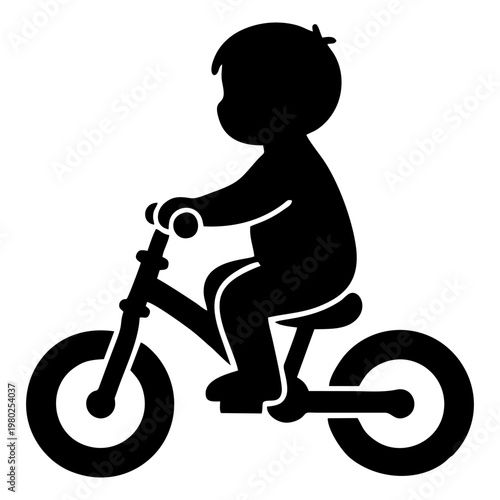 silhouette of a small child riding a balance bike