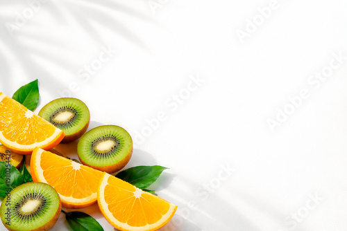Fresh citrus slices and kiwi fruits arranged on white background, summer snack arrangement, vibrant healthy food photography, tropical organic vitamin composition.