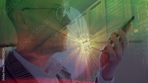 Mid-adult man in suit and glasses bringing phone closer after alert, checking in flare corridor