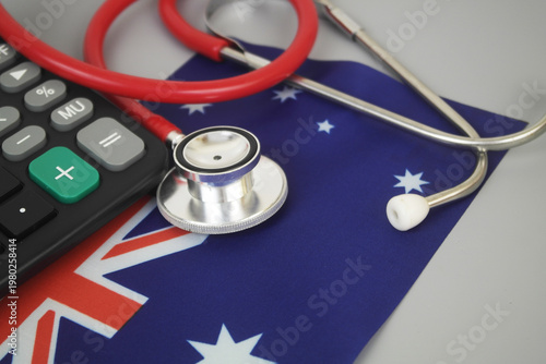 Red stethoscope and calculator on flag of Australia. Cost of Australian medicine and health insurance concept.