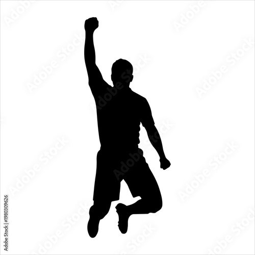 Silhouette of a triumphant man jumping with a raised fist.