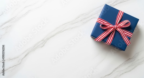 Gift box with red white blue ribbon.