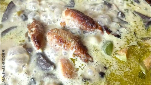 Cooking green curry in pan, indoor Chiangmai Thailand.