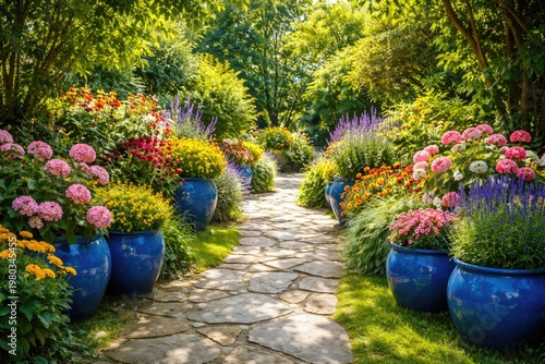 Sunny backyard garden pathway lined with decorative flowering plants in vibrant blue pots and abundant greenery