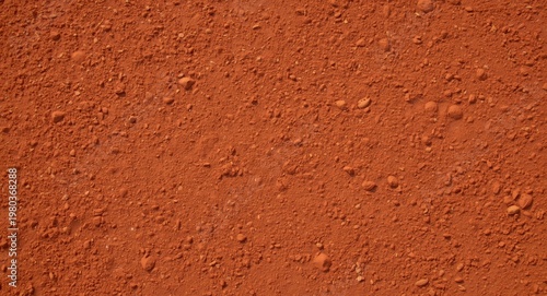 textured dry red clay surface on tennis court backdrop