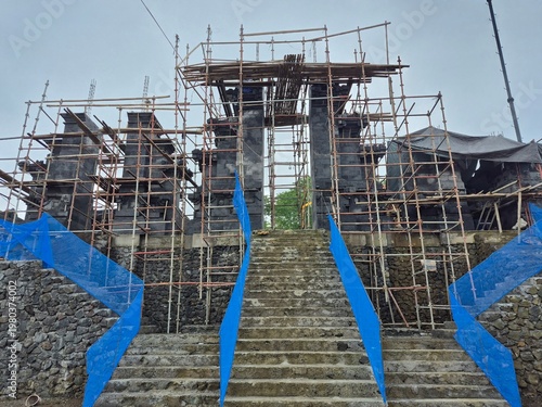  Traditional temple under construction with bamboo scaffolding, cultural architecture development site
