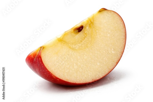A fresh slice of tart apple displaying juicy texture on a plain white backdrop