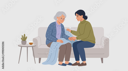 Elderly woman with young caregiver sitting.