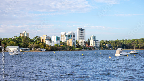 Fotografie Riverside skyline with moored boats across Swan River from Matilda Bay Reserve,
