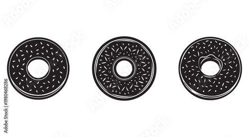 Blackglazed donuts with white sprinkles in different orientations on white background