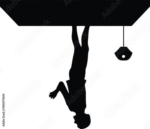 Silhouette of a person standing upside down with a hanging light fixture