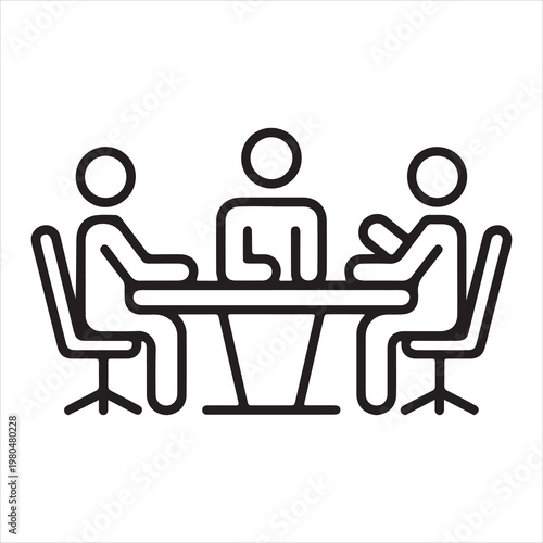 Three people sitting around a table in a meeting or discussion