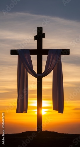 Christian cross with white cloth at sunrise.