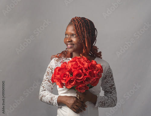 Beautiful Nigerian Woman in Lace Top Holding Roses Studio Portrait