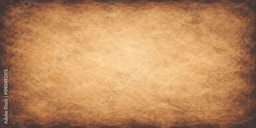 Vintage aged brown parchment paper texture background with a stained grunge design and blank antique pattern on a worn retro sheet