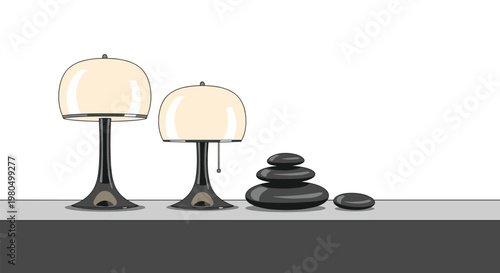 Two modern white table lamps and a stack of black pebbles arranged on a shelf against a plain light grey background.