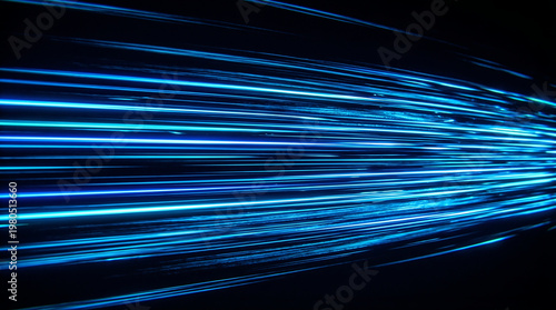 Abstract streaks of bright blue light in motion blur.
