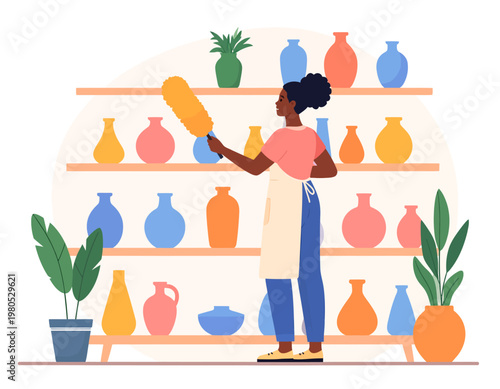 A woman with an apron is dusting colorful vases on wooden shelves with a feather duster.