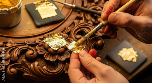 Gilding Process Applying Gold Leaf to Ornate Wood Carving with Brush.
