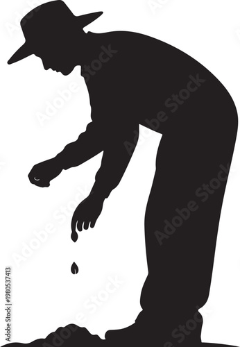 Man in hat bending over to plant seeds