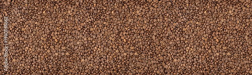 Roasted coffee beans wide large long panoramic texture. Whole bean coffee abstract web banner wallpaper background