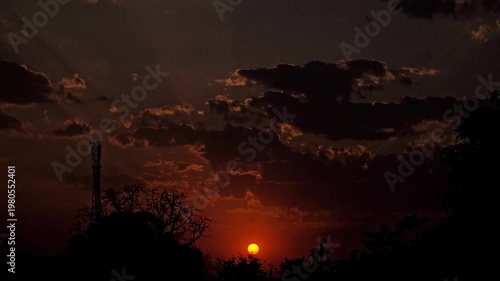 Dramatic Sunset Time-lapse: Sun Descends Below Horizon with Clouds
