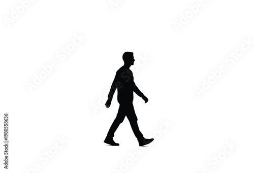 A solitary man is captured walking forward in a striking dark silhouette