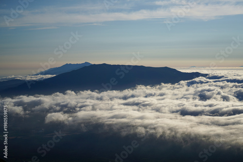 Sea of Clouds Covering Mountain Valley at Dawn, as layers of mist roll through the mountain valleys of Hokkaido, Japan