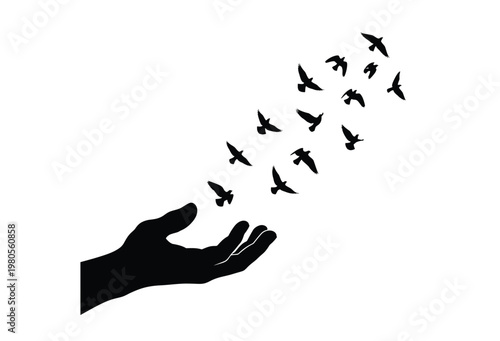 A black hand releasing a flock of birds into the air dramatic silhouette