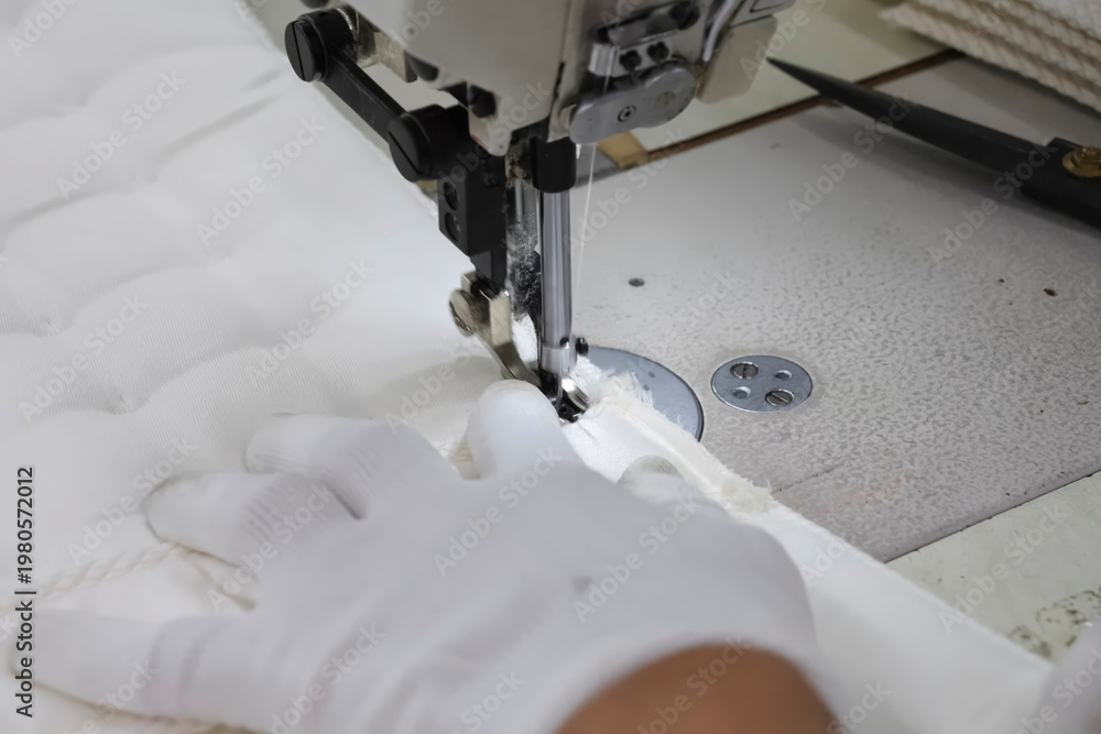 Fototapeta premium Sewing mattress on special machines at garment