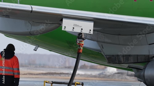 Airplane fueling. Airport technician man refueling aircraft. Terminal airline maintenance crew aviation kerosene fuel. Preparing for departure