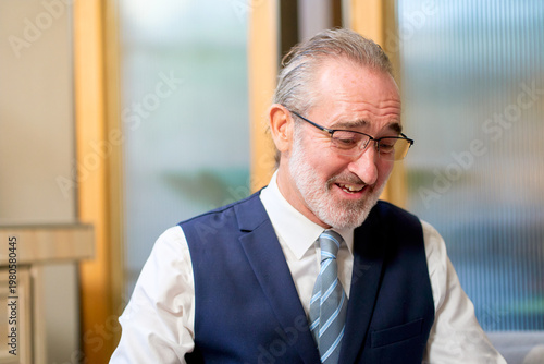 Smile face of businessman in formal suit working in co-working space office.