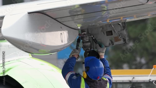 Airplane fueling. Airport technician man refueling aircraft. Terminal airline maintenance crew aviation kerosene fuel. Preparing for departure