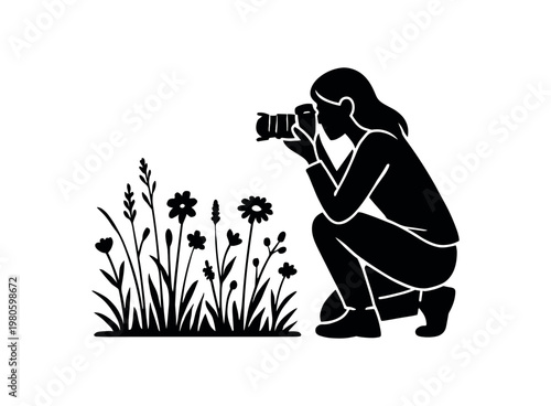 A person kneeling with a camera taking close-up photos of wildflowers, shown as a solid black silhouette suitable for nature, hobby, or workshop icons.